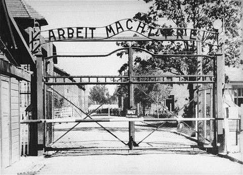 Historical photograph of the entrance gate to the Auschwitz concentration and extermination camp.